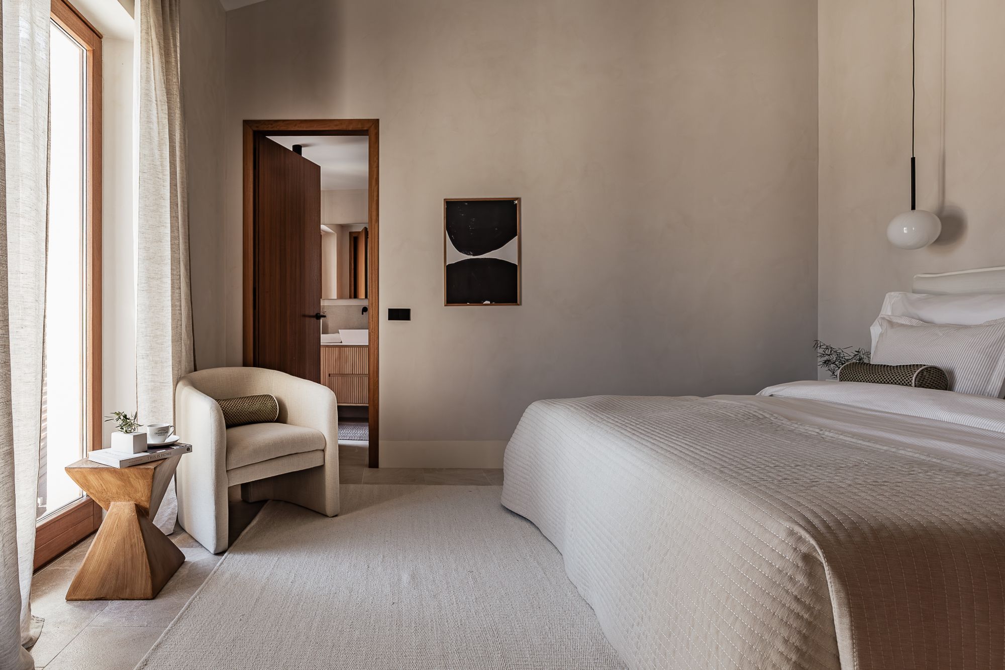 Bedroom with a white bedspread and a decorative cushion